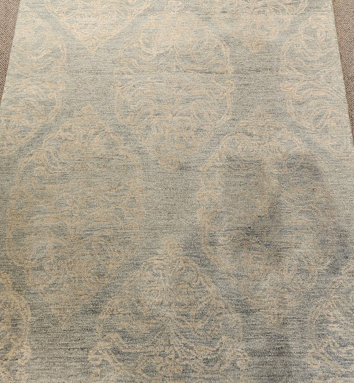 Rizzy Home's Green 2353 area rug, 5'3" x 7'6", features intricate patterns in gray and beige on a carpeted floor.