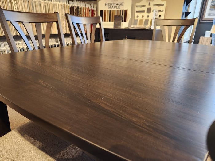 Handstone Parker 7pc Dining Package in showroom with fabric samples and "Heritage Maple" sign.