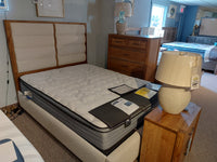 Bedroom with Vaughan Bassett's 790 Erin's Queen Bed, headboard, nightstand, lamp, and dresser; price tags visible.