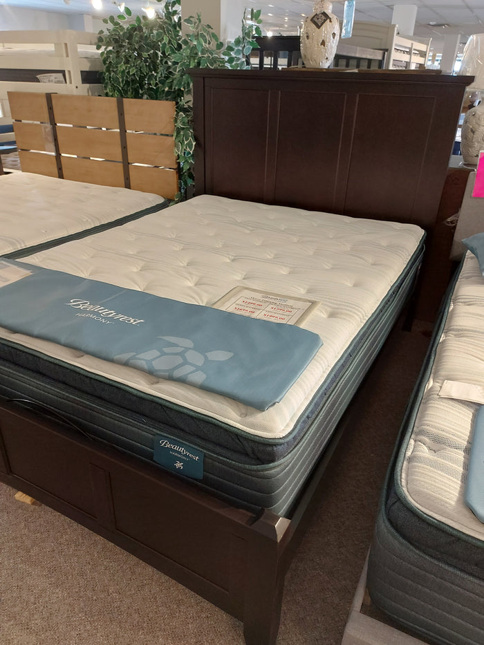 The BB27 Merlot Mansion Queen Bed Frame by Vaughan Bassett is displayed in a furniture store showroom.