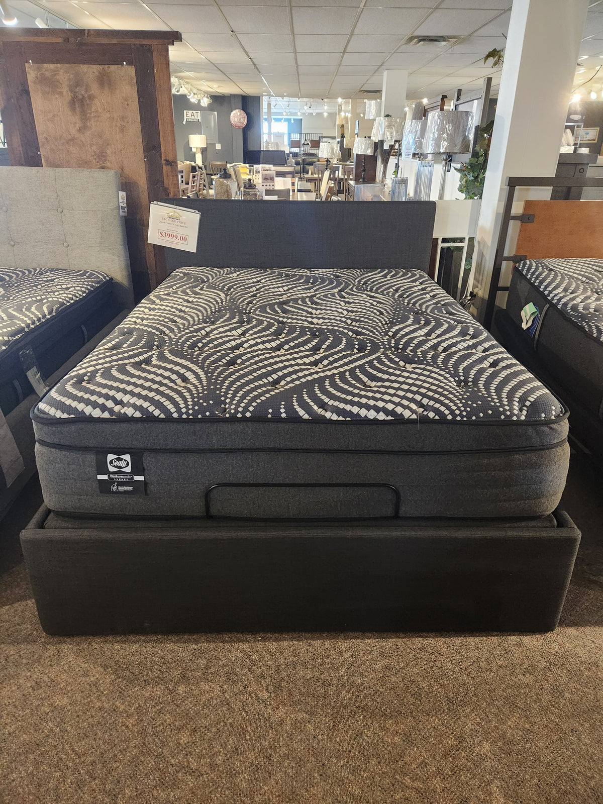 The Julien Beaudoin Ergo Box Adjustable Frame holds a black and gray mattress—ideal for maximizing storage space.