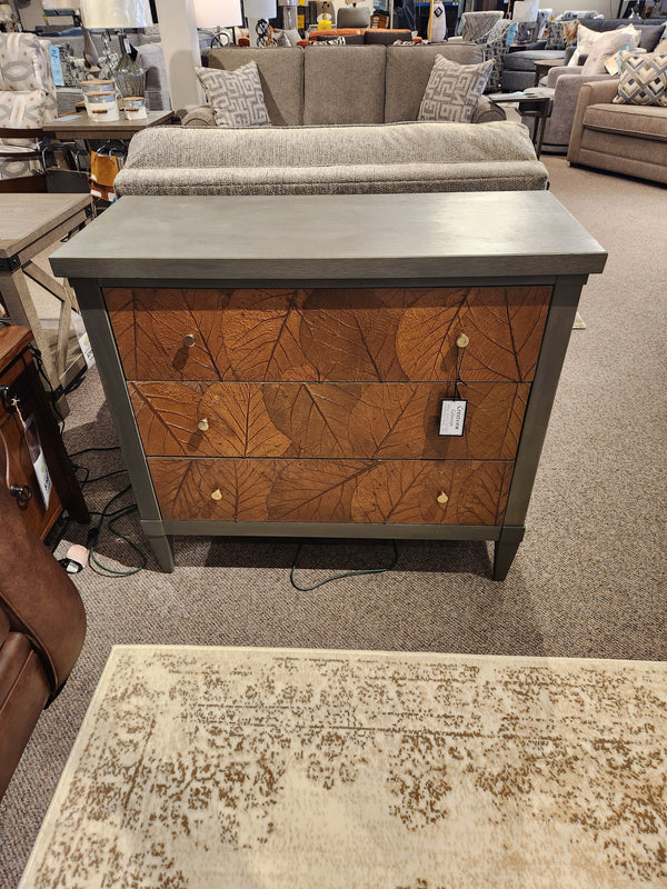 The Crestview Collection Arbor Three Drawer Chest in sage green with leaf pattern drawers, shown as a console table.