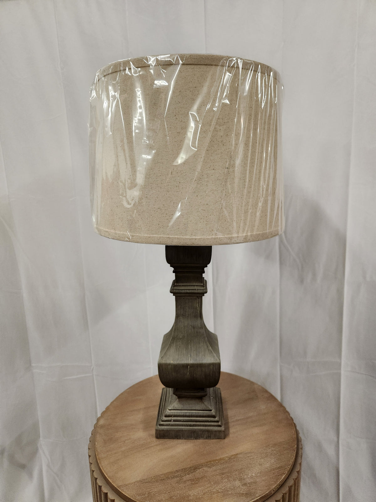 The Pacific Coast Wilmington 60G46 Table Lamp with a beige shade and washed grey finish brings charm to any room.