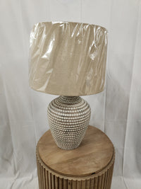 The Pacific Coast 87-10158-21 Table Lamp adds rustic charm with its textured base and wrapped shade to any wooden table.