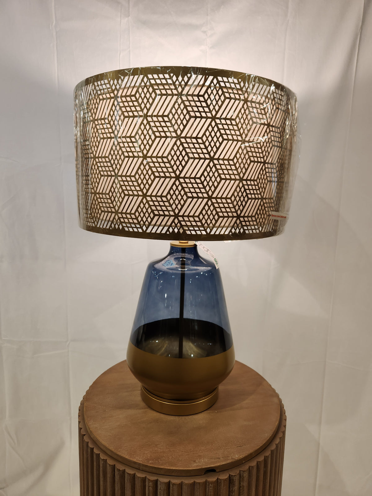 The Pacific Coast 87-08448-51 Taurus Table Lamp features a blue glass finish and gold shade for stylish home decor.
