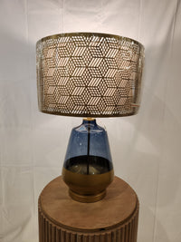 The Pacific Coast 87-08448-51 Taurus Table Lamp features a blue glass finish and gold shade for stylish home decor.
