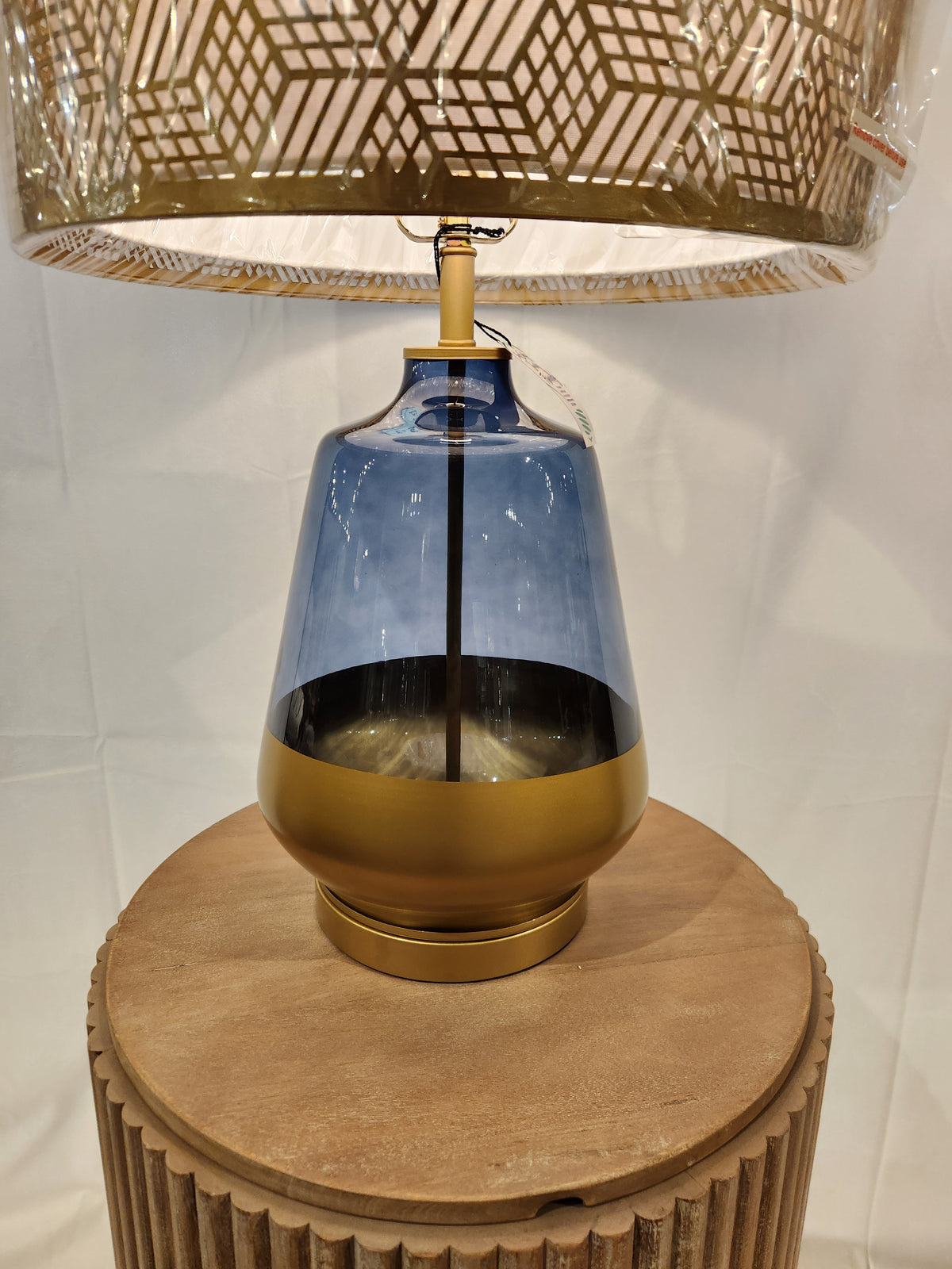 The Pacific Coast 87-08448-51 Taurus Table Lamp has a blue and gold glass base, perfect for your round wooden table.
