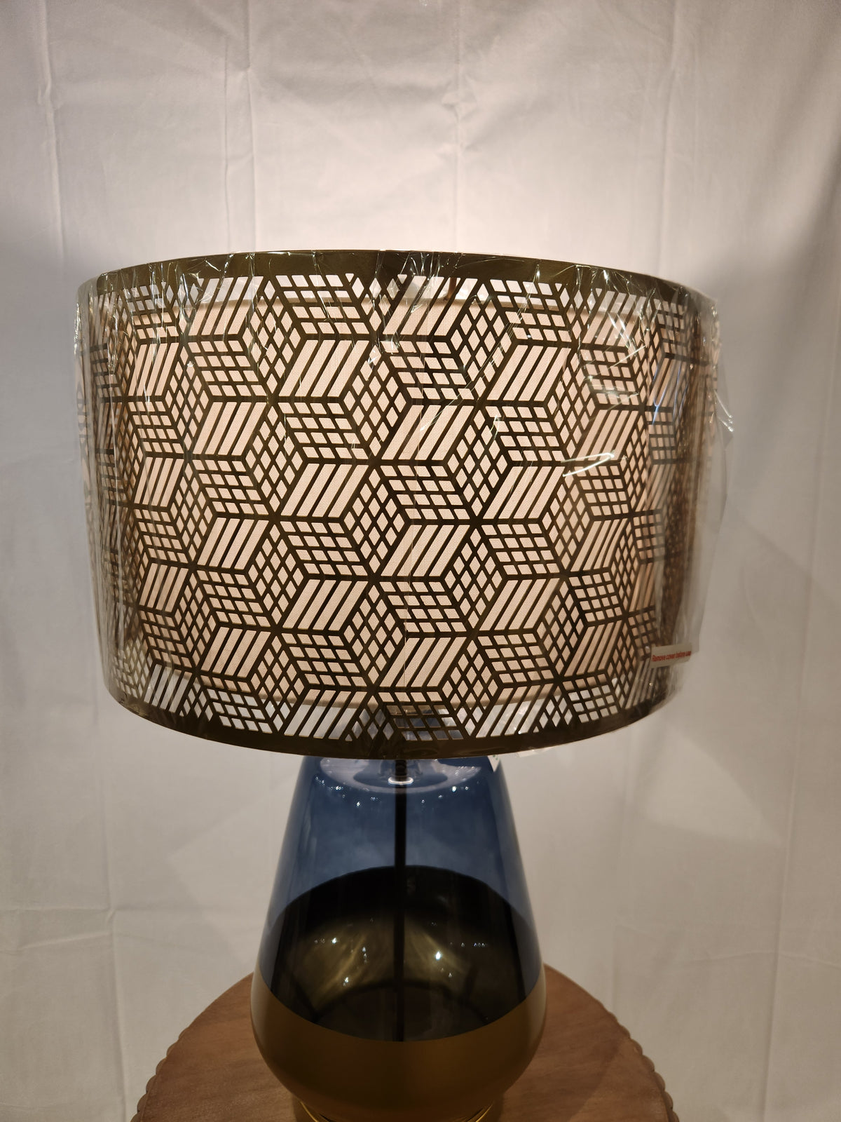 The Pacific Coast 87-08448-51 Taurus Table Lamp features a blue glass finish and geometric shade for stylish decor.