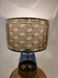 The Pacific Coast 87-08448-51 Taurus Table Lamp features a blue glass finish and geometric shade for stylish decor.