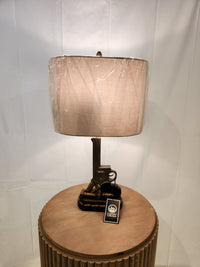 Quick Draw Table Lamp by Crestview Collection: Features a unique handgun design with touch controls, beige shade, wooden stand.