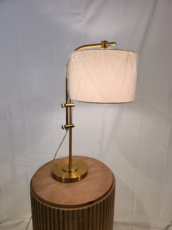 Ashley Baronvale L206053 table lamp with adjustable arm and white drum shade on a round wooden side table.