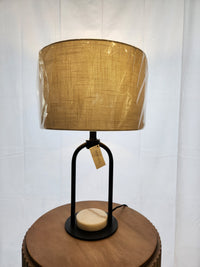 The Mercana 69702 Sarah Table Lamp has a tan shade, black arched frame, and white marble base.