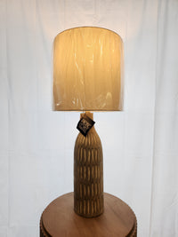 The 73E50 Stonewall Table Lamp by Pacific Coast features a hand-carved base and wrapped shade for a refined look.