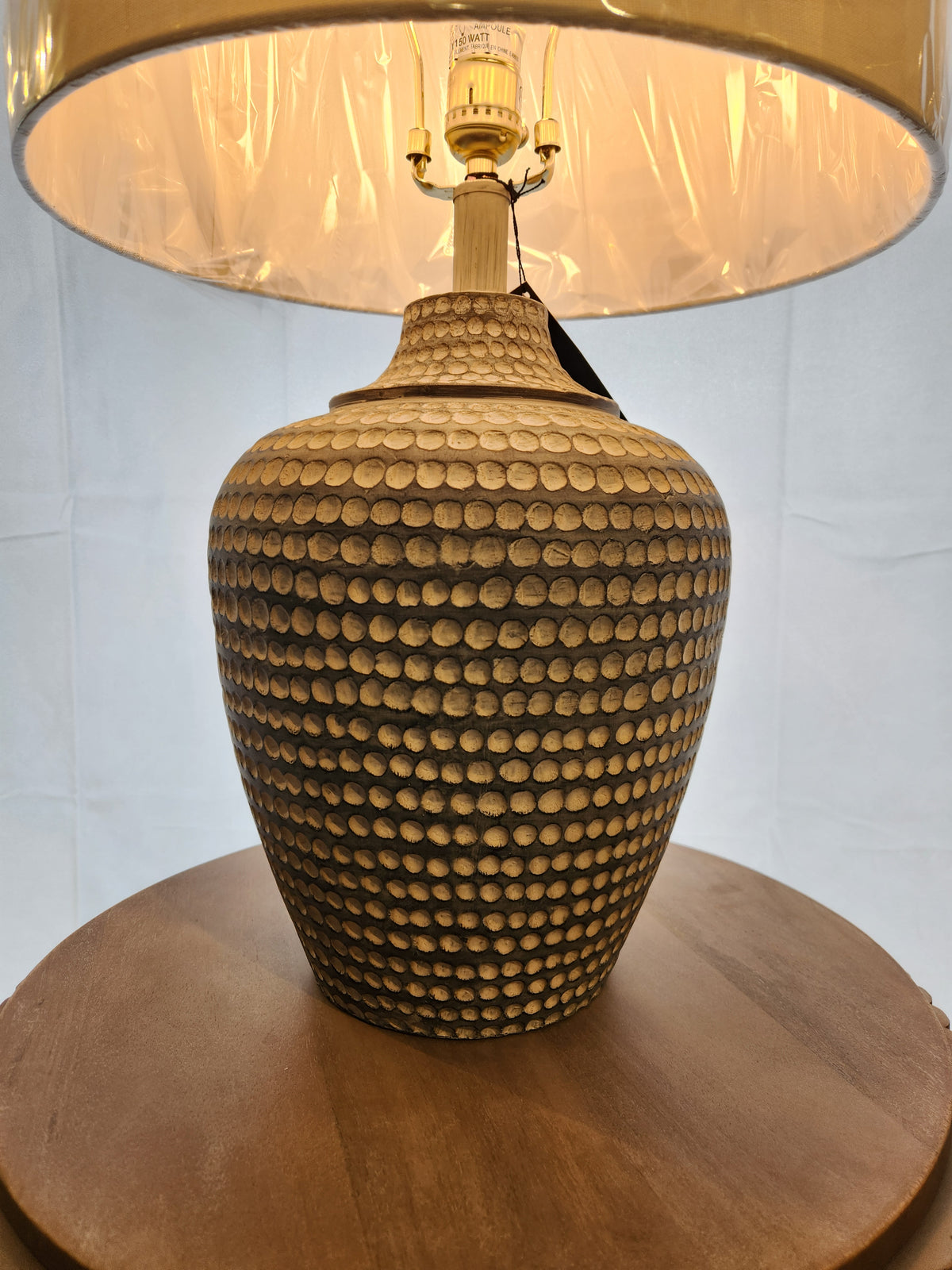 The 767H1 Alese Table Lamp by Pacific Coast features a textured ceramic base and beige shade for modern sophistication.