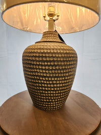 The 767H1 Alese Table Lamp by Pacific Coast features a textured ceramic base and beige shade for modern sophistication.