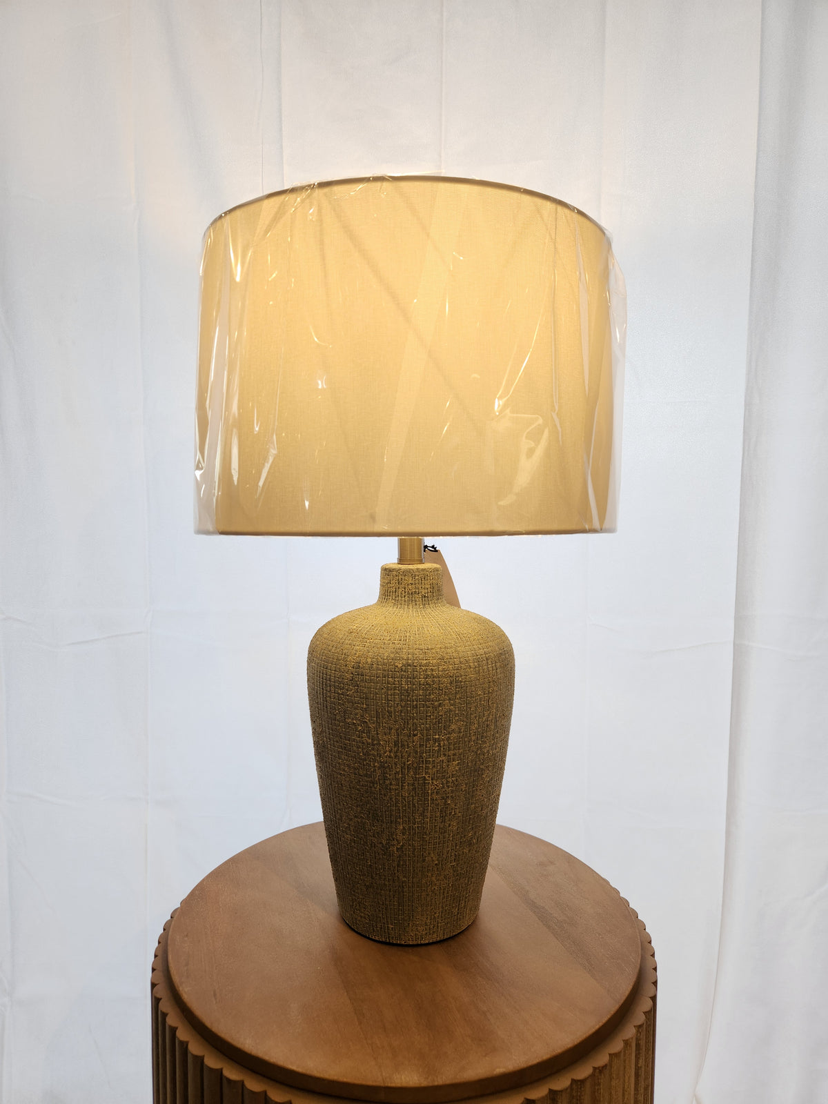 The Pacific Coast 861D0 Reid Table Lamp features a beige ceramic urn base, ideal for modern decor.