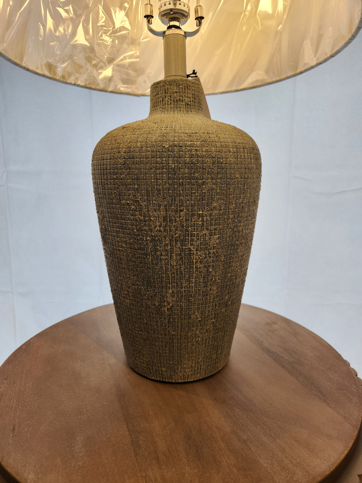 The Pacific Coast 861D0 Reid Table Lamp with a textured ceramic base is perfect for modern decor.