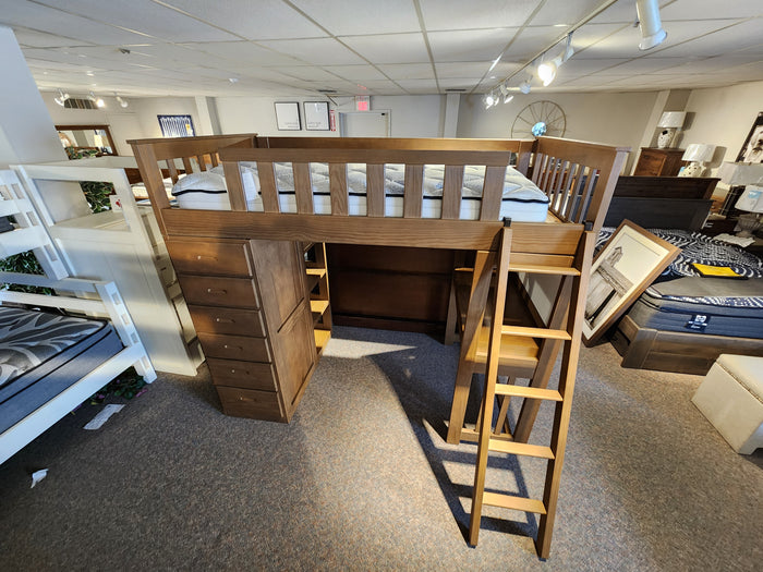 Crate B43200 Versa Loft Bed in Southern Yellow Pine with built-in drawers and ladder shown in furniture showroom.