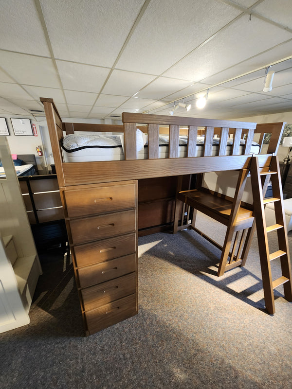 The Crate B43200 Versa Loft Bed is made from Southern Yellow Pine, with drawers, ladder, and desk/seating space in showroom.