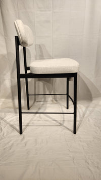 The Orly Counter Height Bar Stool by Amisco features a modern light gray padded seat and backrest with an antiqued black finish.