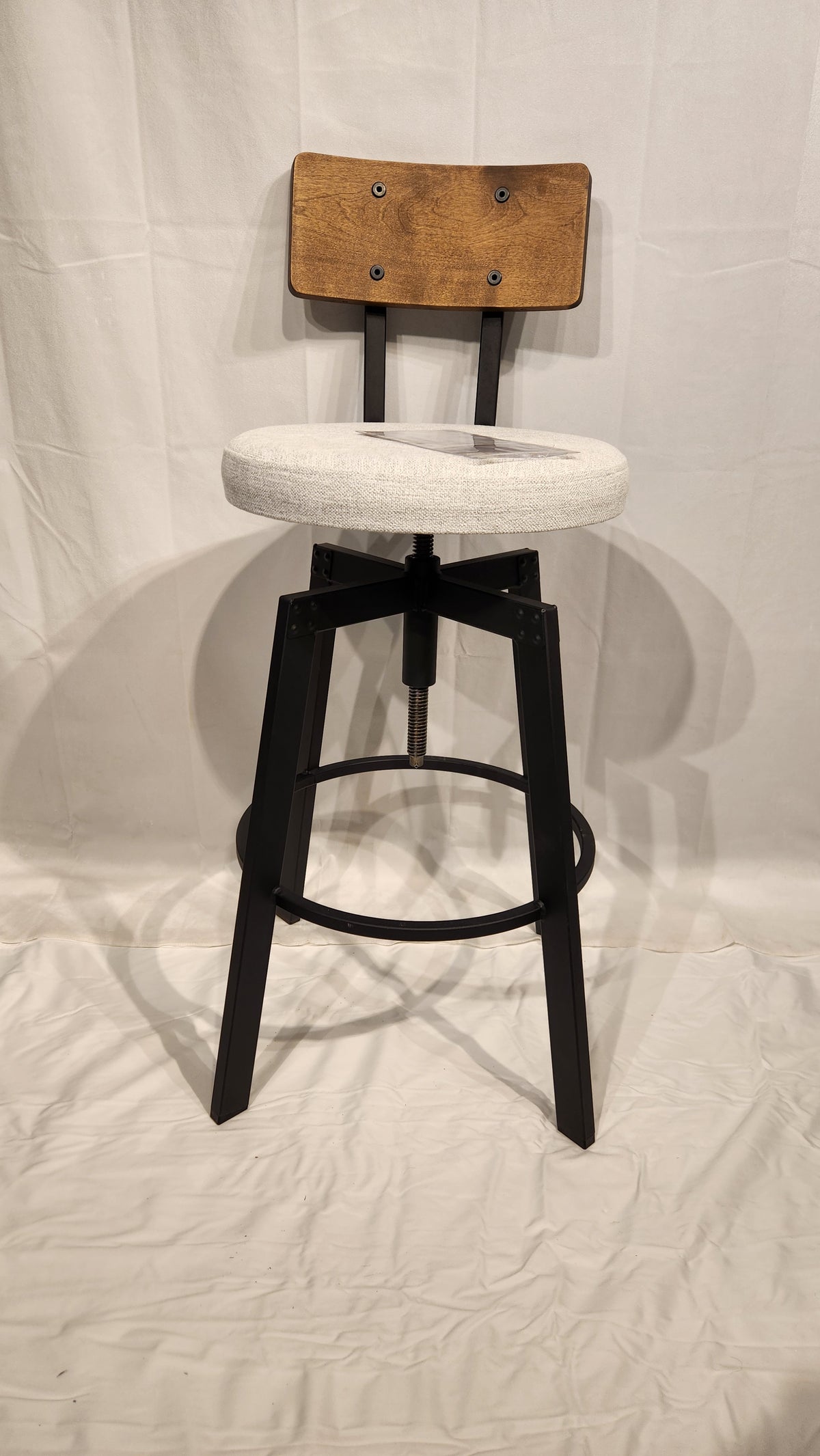 An Amisco Architect Black Coral Counter Stool with white cushion, black metal frame, on a plain white backdrop.