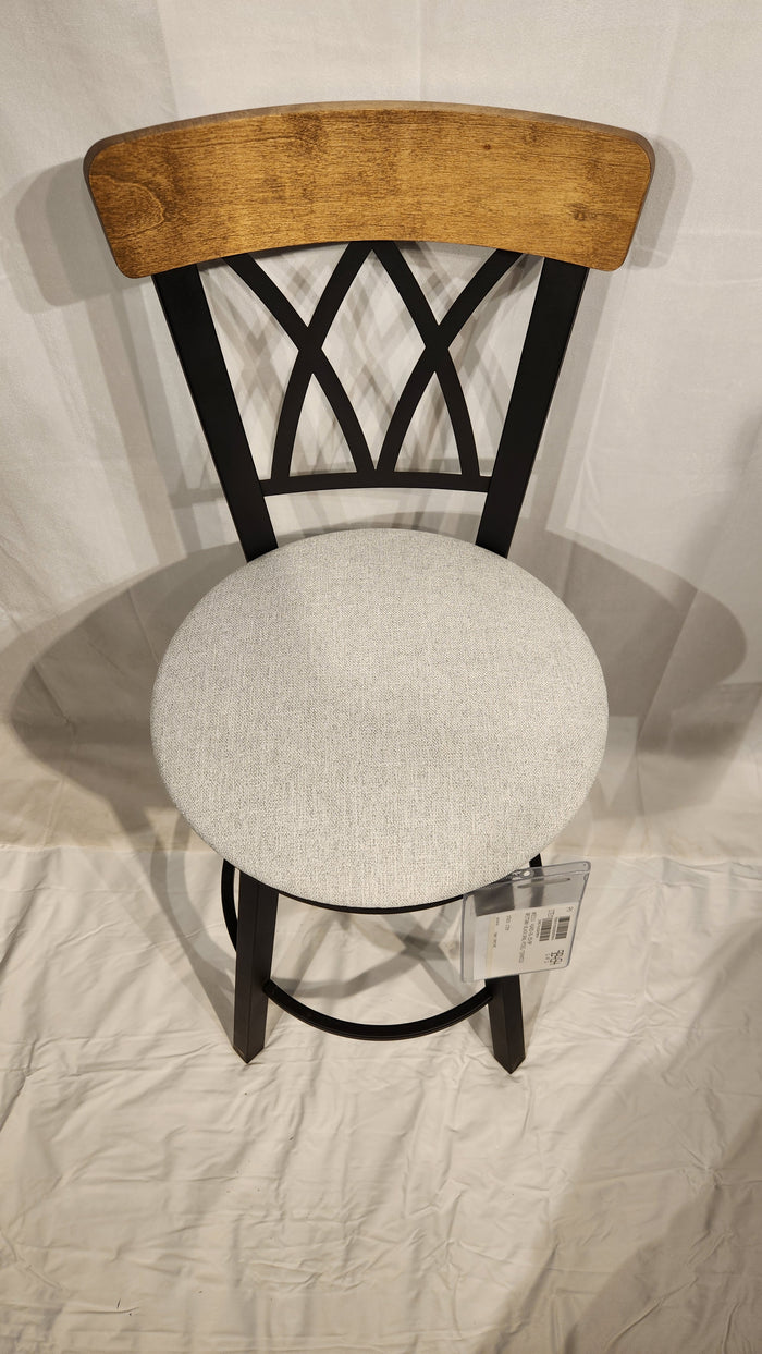 The Amisco Brittany Counter Height Swivel Bar Stool features a light gray cushioned seat and vintage-style finishes.