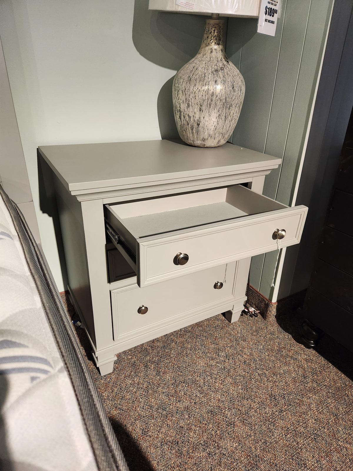 Magnussen B5611 Charleston Nightstand with two drawers and a ceramic lamp—ideal for a modern farmhouse bedroom.