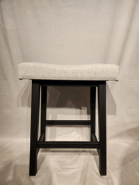The Amisco Miller Counter Height Bar Stool features a light gray cushion and black wooden legs against a neutral backdrop.