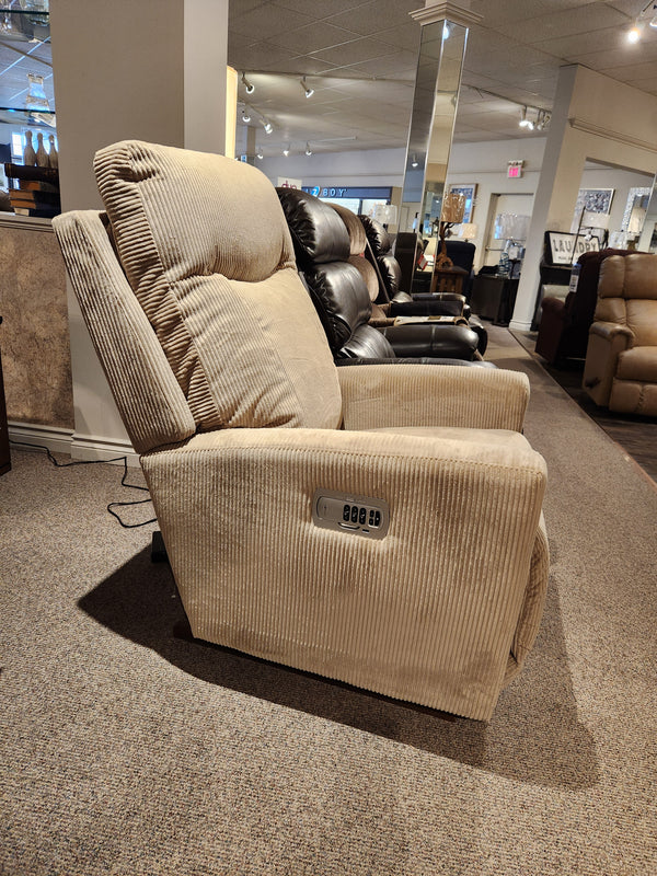 La-z-boy's 715 Kodie Power Rocker Recliner in beige corduroy featured in a stylish living area with other elegant recliners.