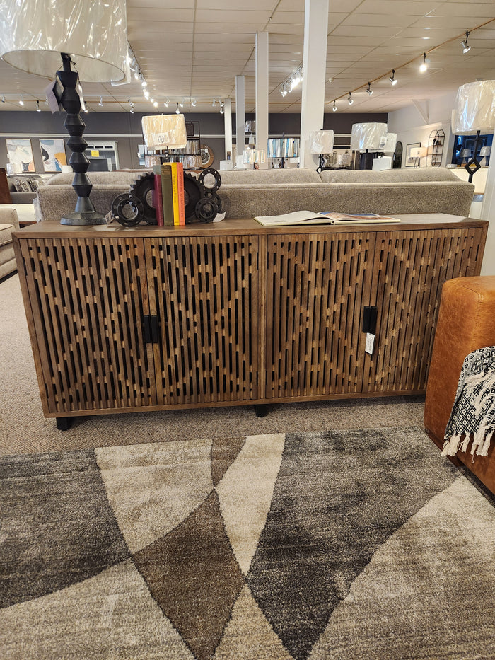 Lavelle 4 Door Sideboard by Crestview Collection is styled with books and art in Memphis, TN showrooms.