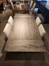The Amisco Lewis 36"X48" Table Package, with six chairs, creates a modern dining space in the showroom.