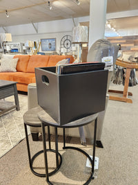 SB101 Record Crate by Mercana on stacked round side tables; ideal for vinyl lovers. Orange sofa in background.