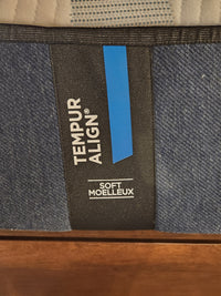 The Tempur-pedic Align - Soft mattress label features "Soft Moelleux" on blue and black fabric for pressure relief.