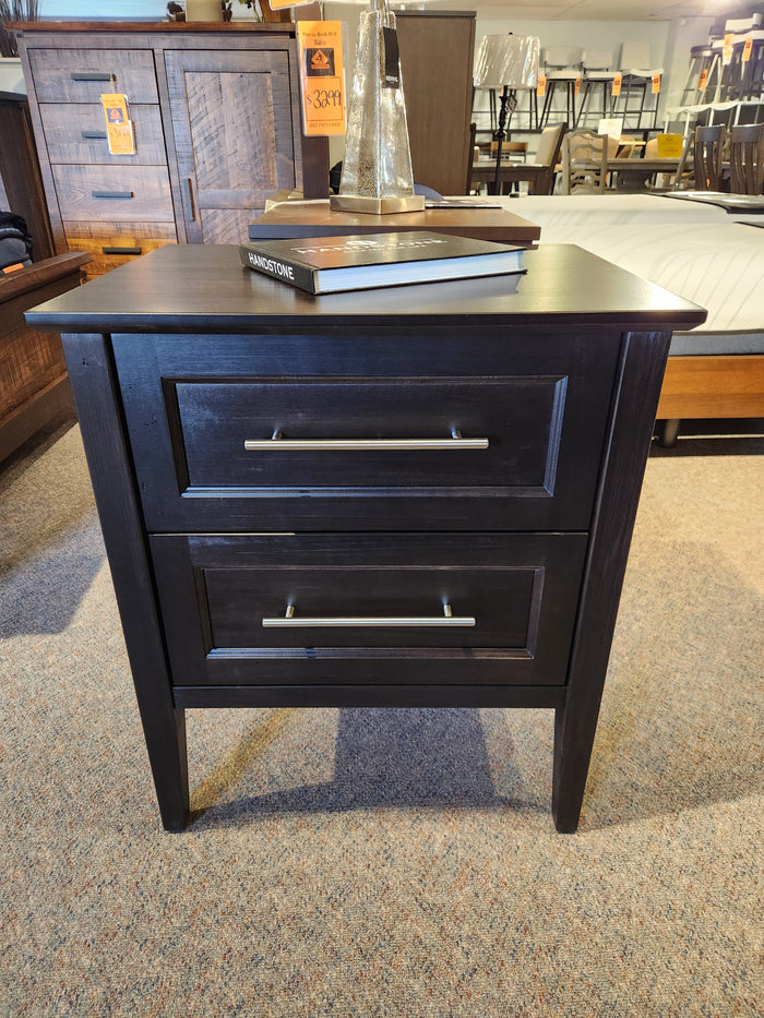 The Handstone Stockholm 2-Drawer Nightstand, featuring sleek detailing, is showcased in a store display.