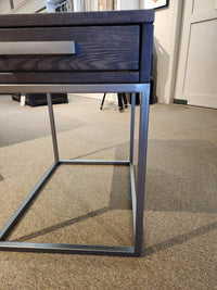 Handstone's Muskoka 24" End Table with a metal frame and solid oak top sits elegantly on a beige carpeted floor.