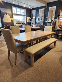 Handstone Retreat 7pc Dining Package with Double Pedestal Table, four upholstered chairs, and a bench on carpet.