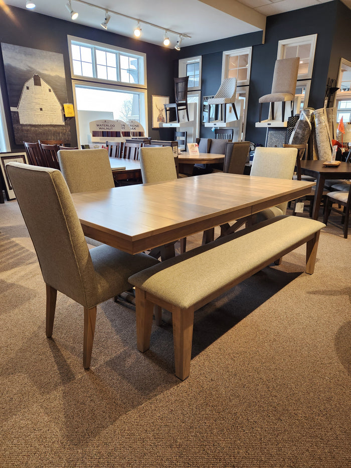 Handstone Retreat 7pc Dining Package with Double Pedestal Table, four upholstered chairs, and a bench on carpet.