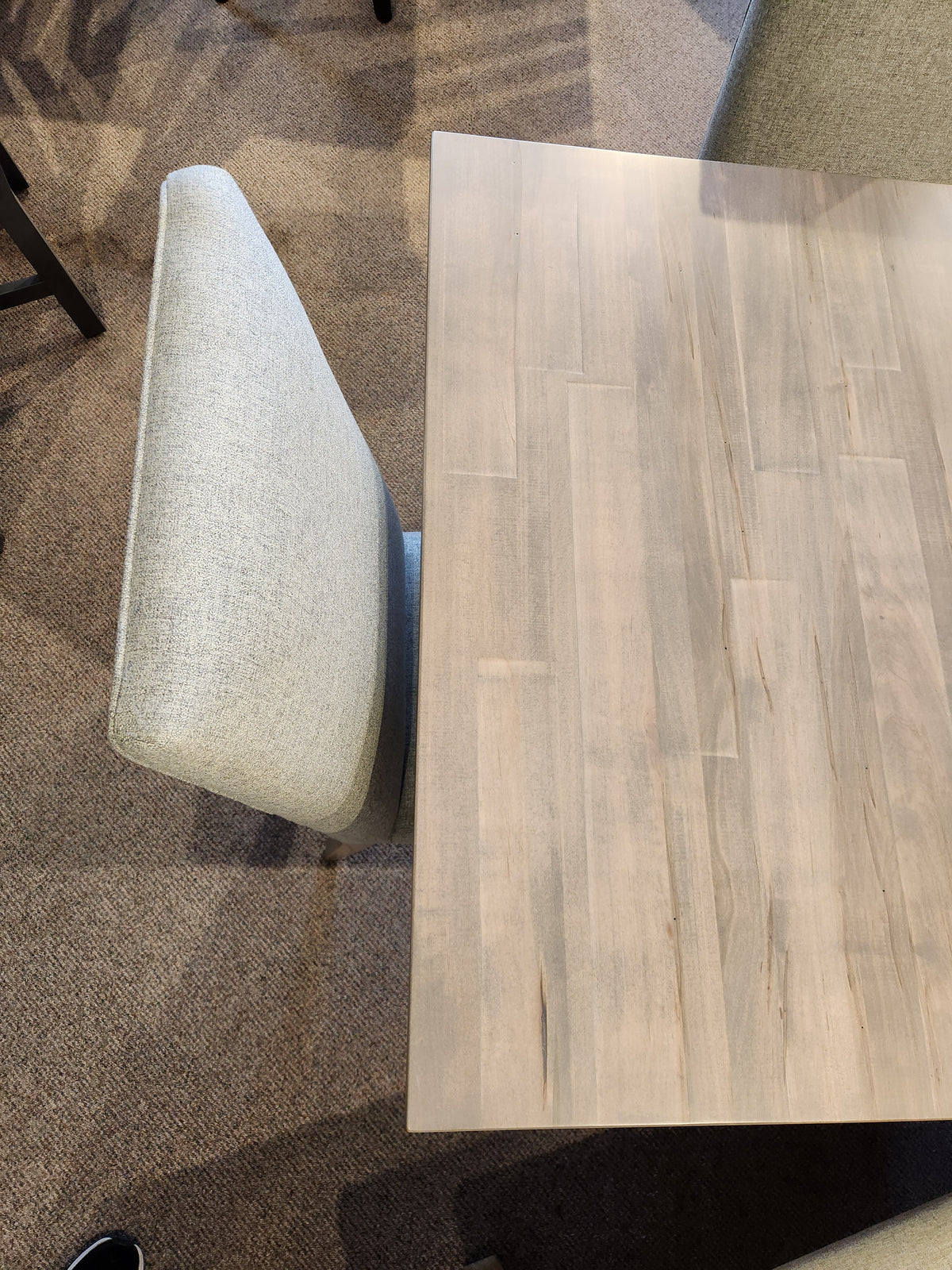 Top view of Handstone Retreat 7pc Dining Package with a gray chair on a beige carpet.