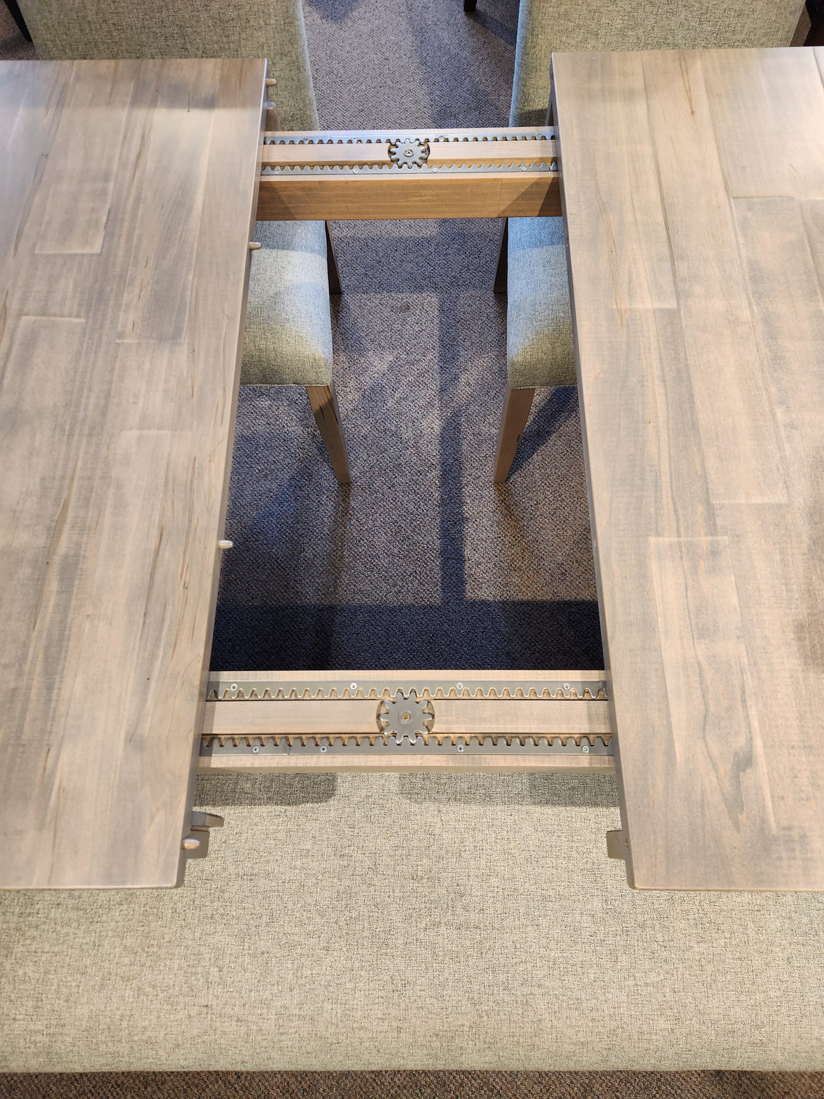 A Handstone Retreat 7pc Dining Package with a wooden table featuring a double pedestal and an internal sliding mechanism.