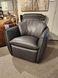 A modern dark gray 752 Swivel Chair by Leather Craft with cushioned seating, featured in a Toronto handmade furniture showroom.