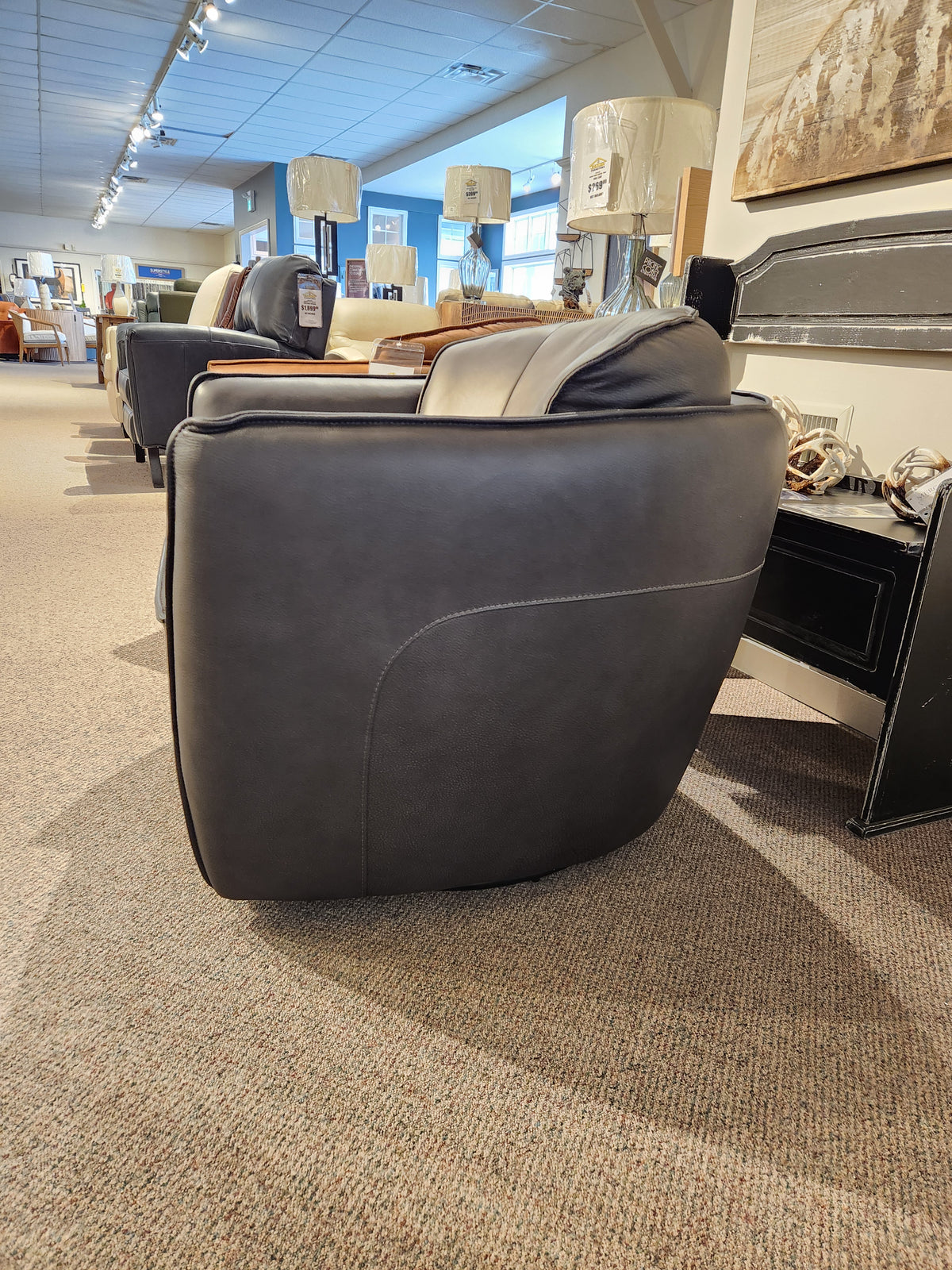 The 752 Swivel Chair by Leather Craft displayed with lamps and other handmade Toronto furniture.