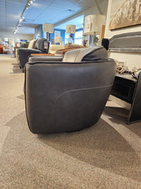 The 752 Swivel Chair by Leather Craft displayed with lamps and other handmade Toronto furniture.