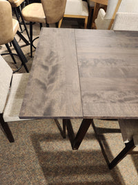 Amisco's Alex 36"x60" dining set features a solid top with cushioned chairs, ideal for carpeted rooms.