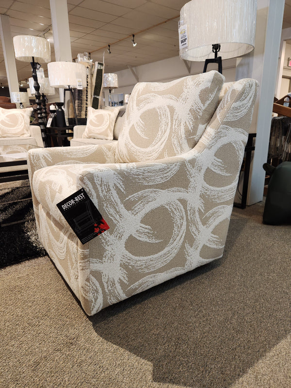 Beige 2627 Swivel Accent Chair by Decor-rest with white swirls and sloped arms displayed in a furniture store with tag.