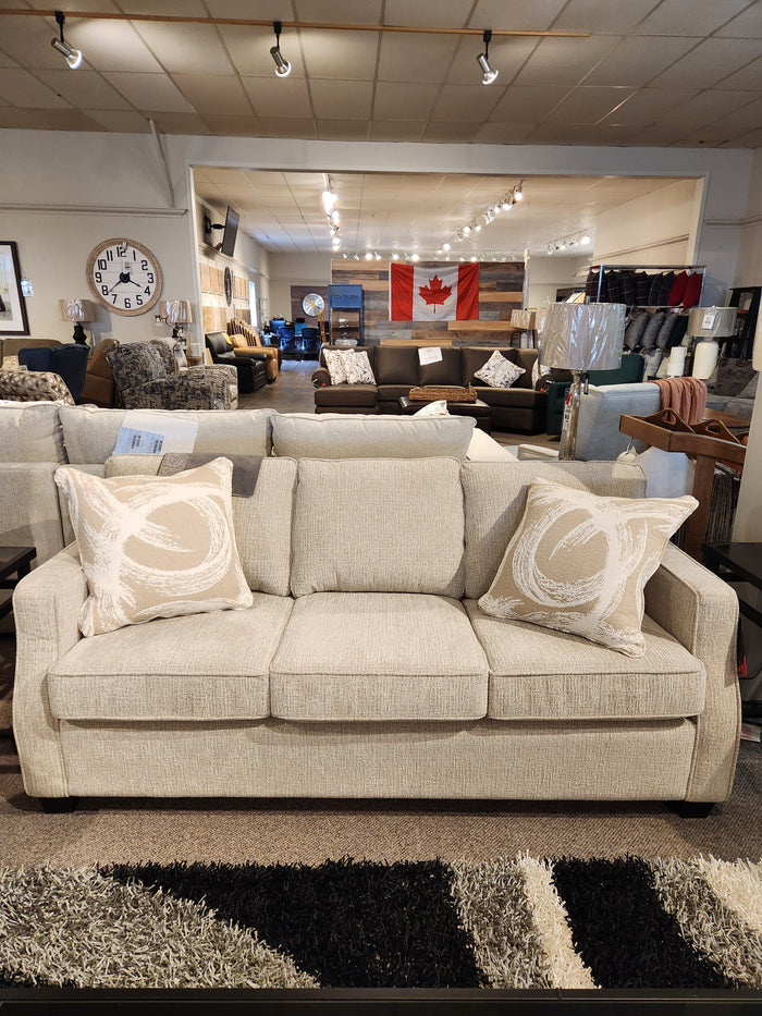 The Canadian-made beige Decor-rest 2570 Stationary Sofa with patterned cushions is ideal for small spaces.