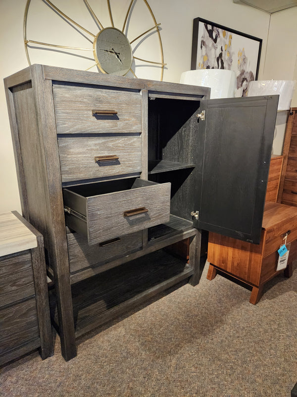 The Magnussen B5990 Plum Creek Door Chest features a Ravenwood Black finish, three drawers, and open shelves.