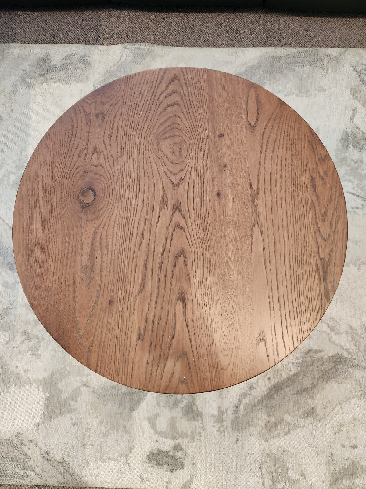 The Rory 29" Coffee Table by Donald Choi features visible grain, ideal for small spaces, on a textured light rug.