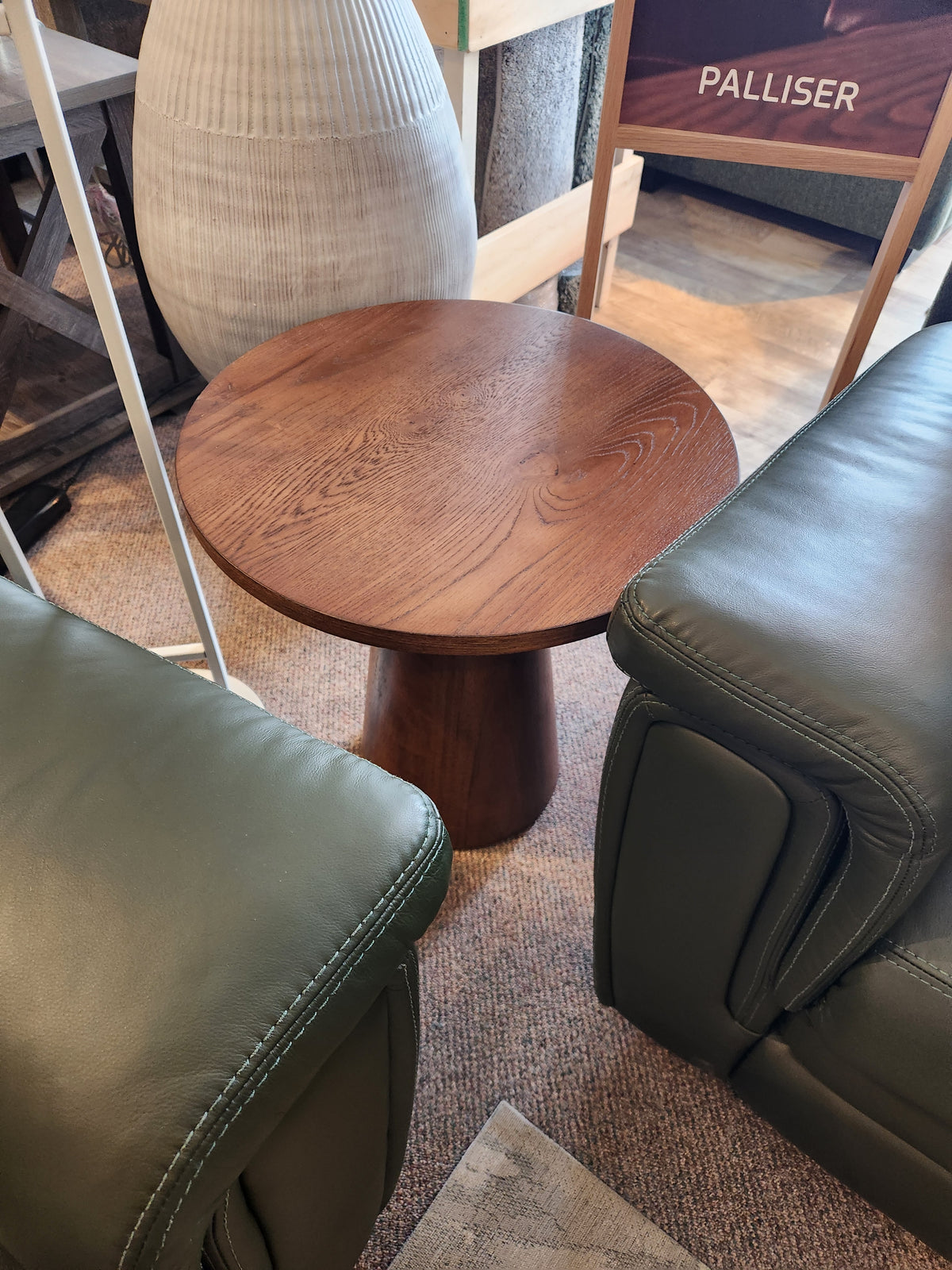 Compact Rory 20" Chair Side Table by Donald Choi fits small spaces, perfect between green leather chairs on carpet.