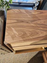 A Palliser EQ3 Monarch Chest with walnut veneer, closed top, and open lower drawer, seen from above.