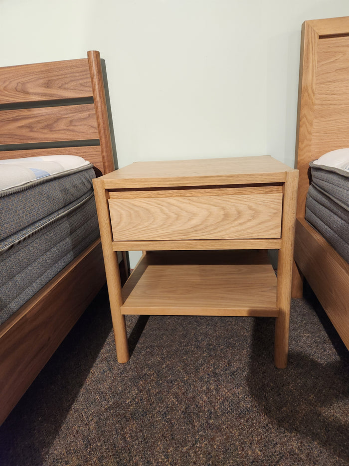 The Palliser EQ3 Monarch Single Drawer Nightstand sits between two beds, complementing the Monarch bedroom collection.